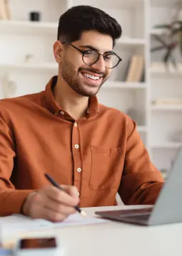 A man in his new prescription glasses using a laptop.