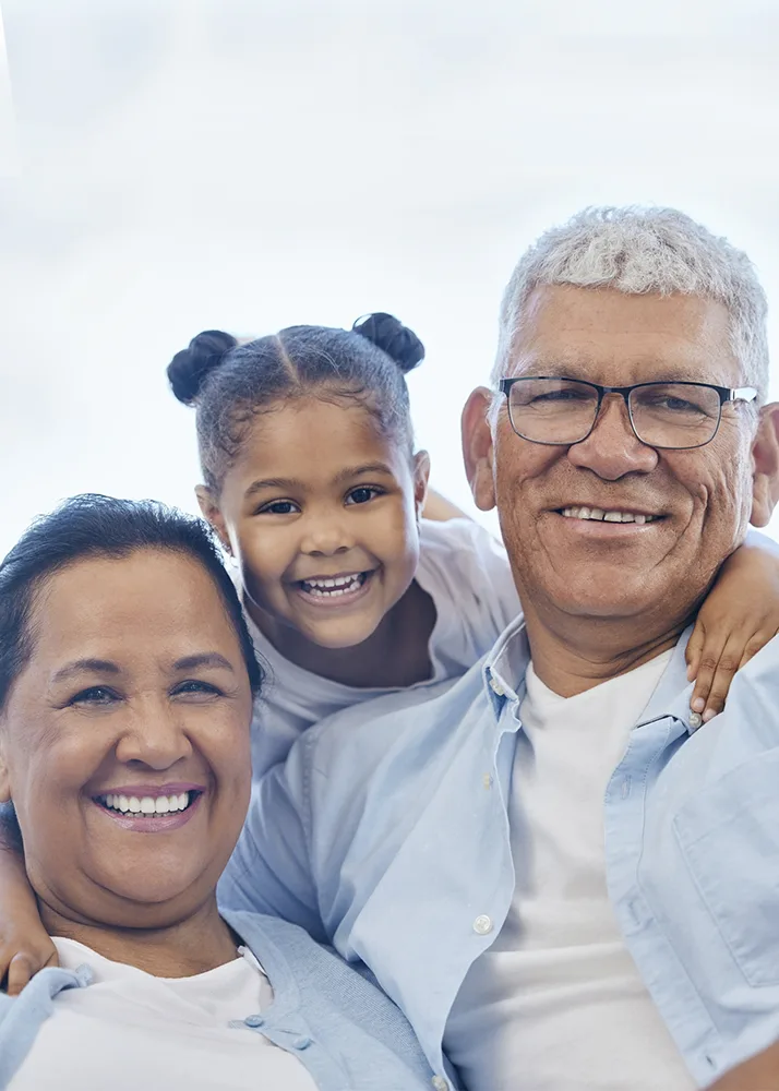 Two parents and their child are smiling after the dentist appointment paid for by dental insurance.