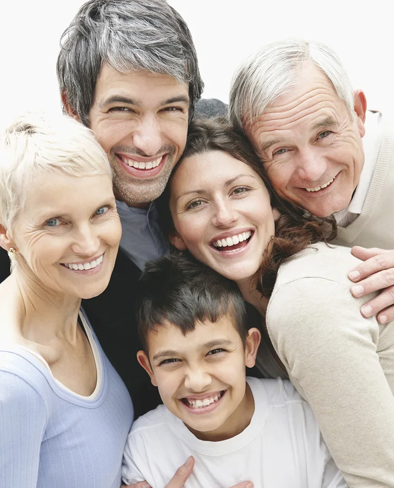 A family of five smiling because they are insured against critical illnesses.