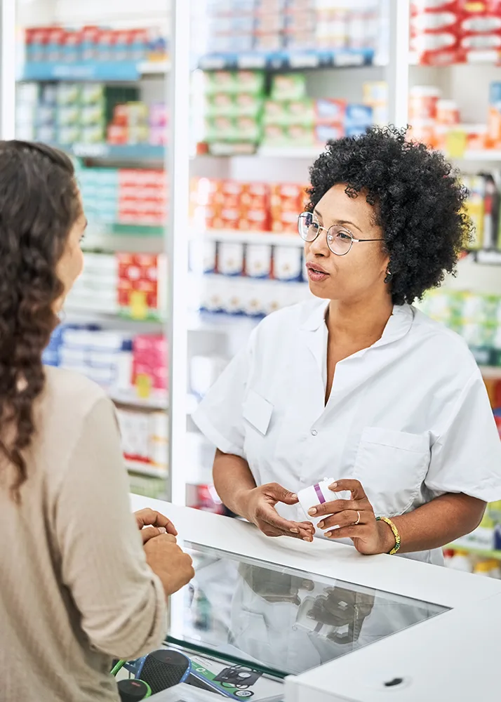 A pharmacist explaining to a client how prescription insurance works.