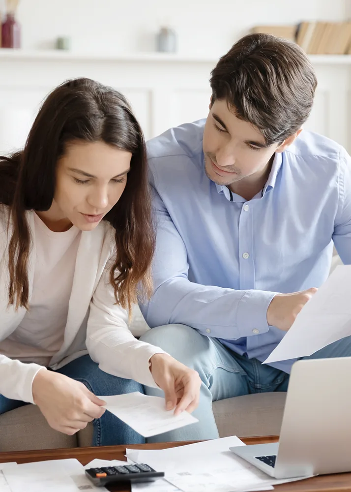 A couple reading about short-term medical insurance.