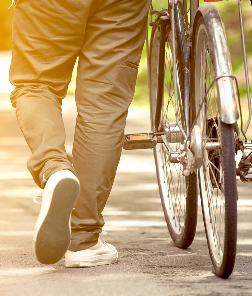 Man walking next to his bike.
