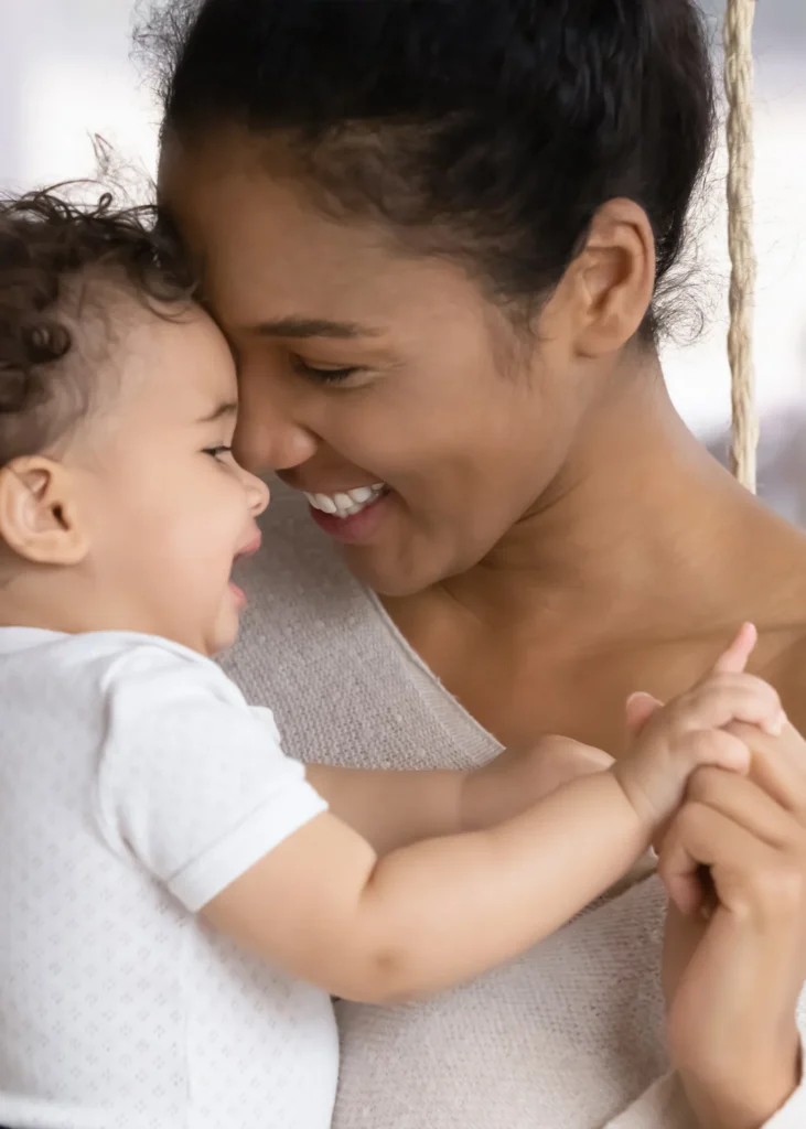 Smiling mother holding her baby.