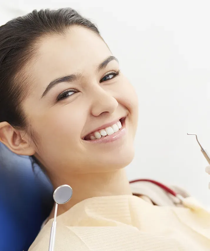 A woman smiling because dental insurance paid for her dentist appointment.