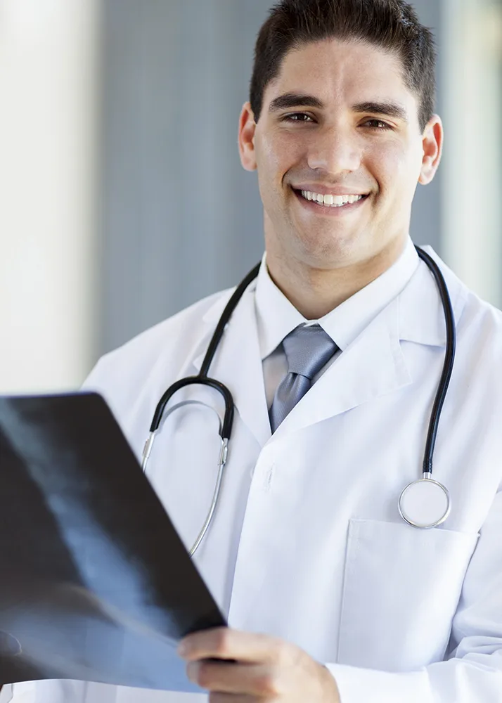 A doctor holding a radiograph.
