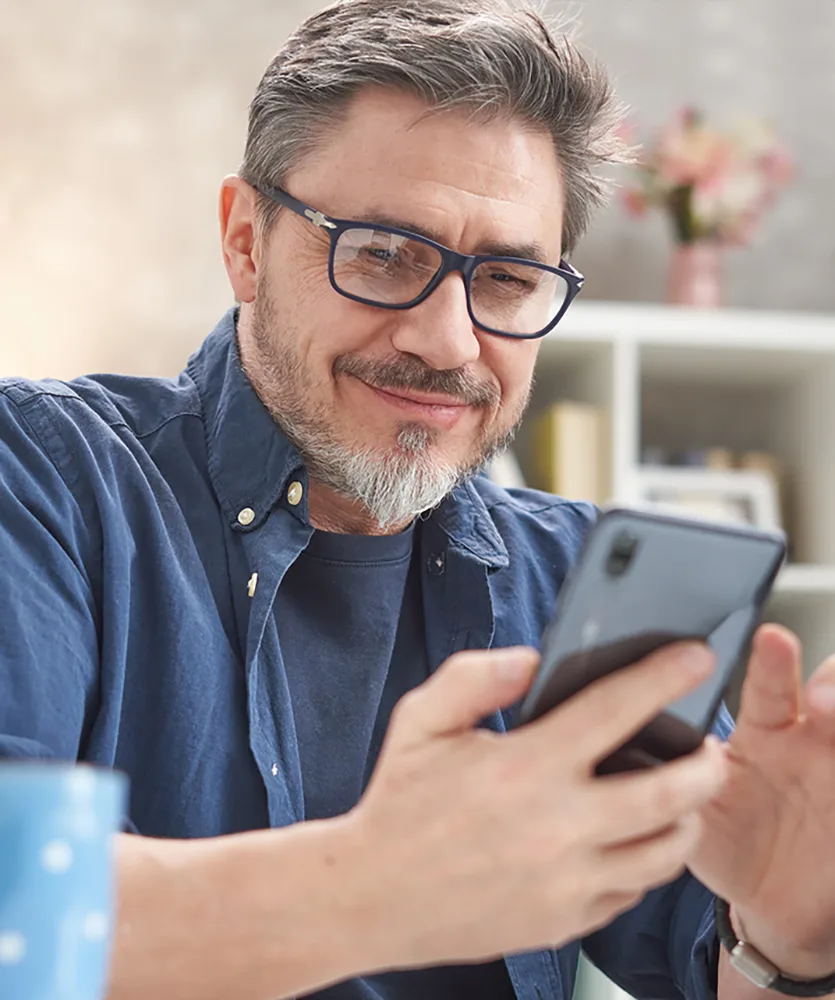 A man using his phone to check out disability insurance products.