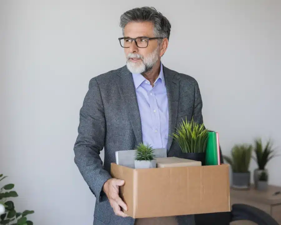 Man walks out of office with belongings, needing insurance